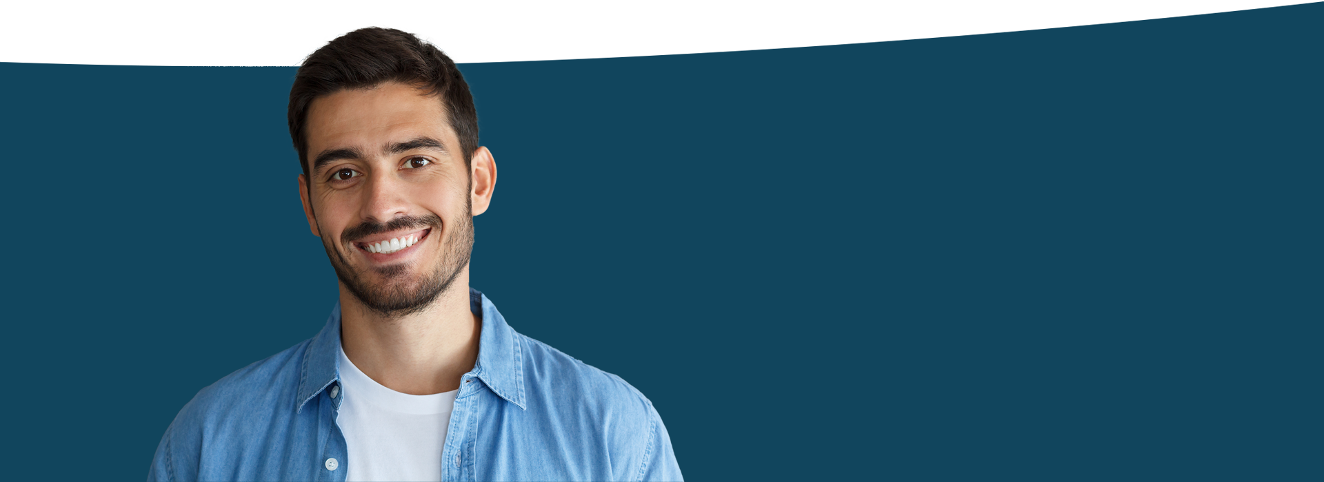 The image features a person standing against a blue background, smiling at the camera.